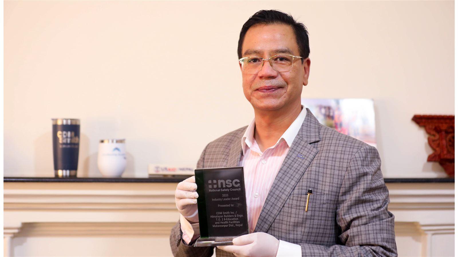USAID’s NRES Chief of Party Rajeev Thapa holds the National Safety Council's 2020 Industry Leader Award.