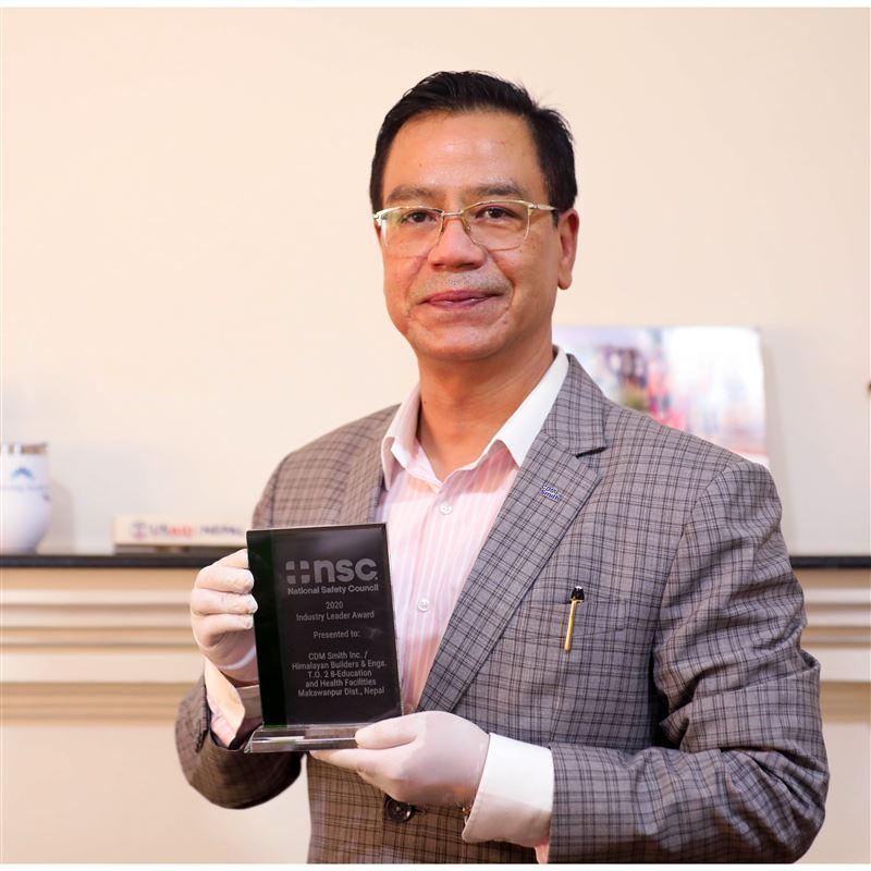 USAID’s NRES Chief of Party Rajeev Thapa holds the National Safety Council's 2020 Industry Leader Award.