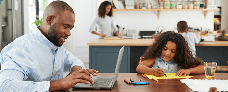 Male and little girl working at kitchen table