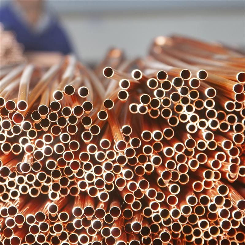 A large stack of freshly cut pipes